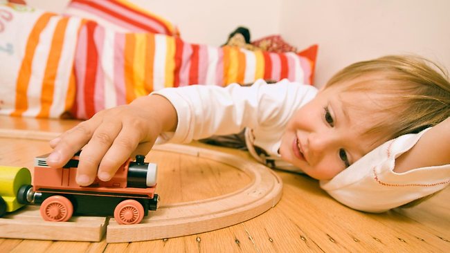 203801-boy-playing-with-toy-train